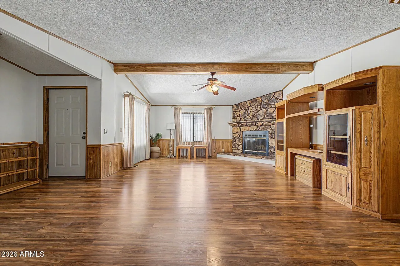 Living room opening toward the kitchen under a vaulted ceiling