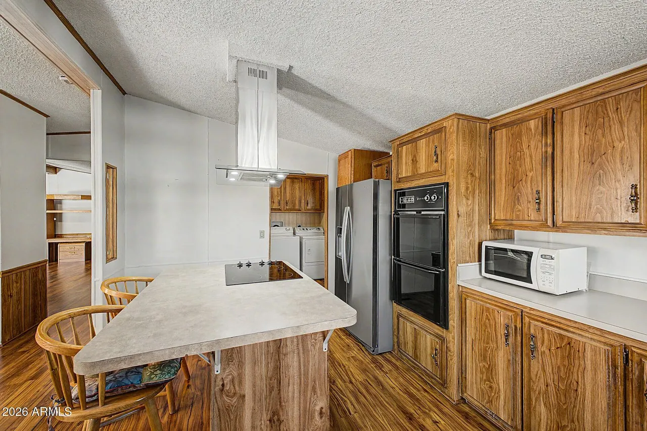 Full kitchen view with wood cabinets and counter space