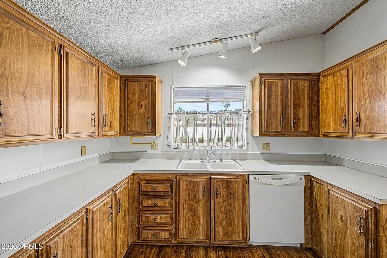 Kitchen with wood cabinetry and window over the sink