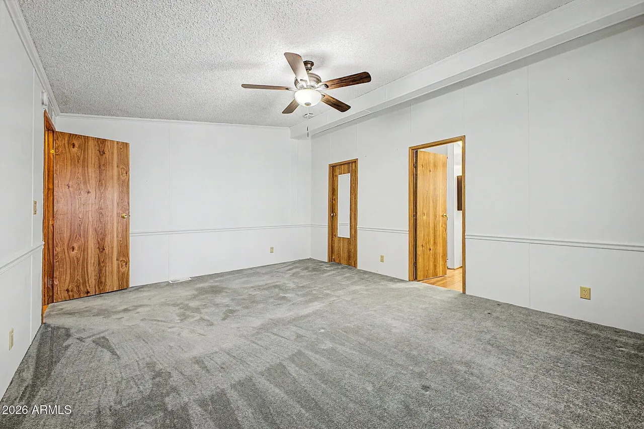 Second bedroom with carpet, ceiling fan, and natural light