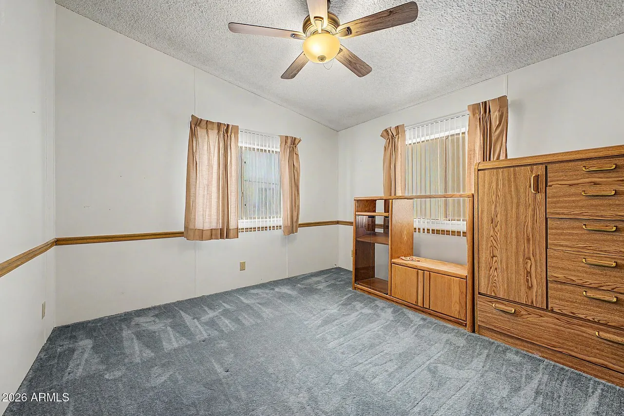 Carpeted bedroom with ceiling fan